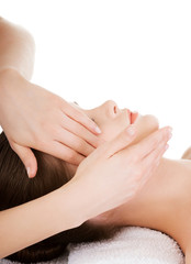 Relaxed woman enjoy receiving face massage