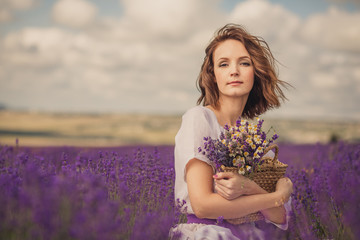Smiling beautiful brunette in the lavender field