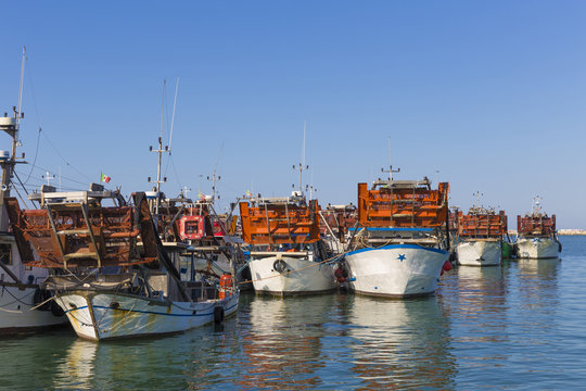 fishing boats in harbor - machine to collect the clams