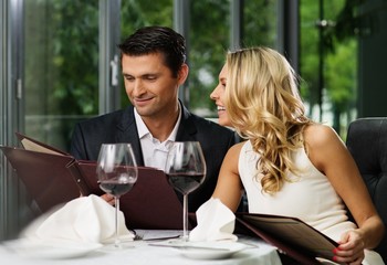 Cheerful couple with menu in a restaurant