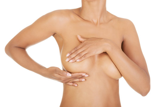 Adult woman examining her breast
