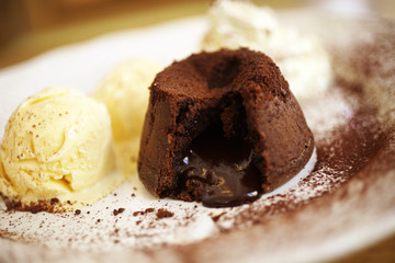 close up chocolate cake and vanilla icecream in coffee shop
