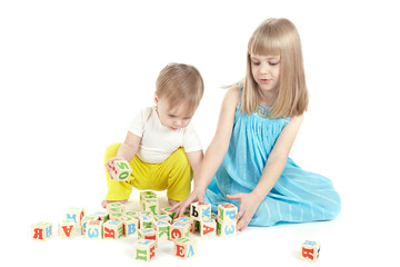 Two children play with cubes