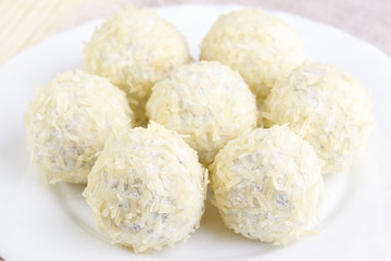 Cheese balls with a tomato cherry inside