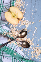 Apple with oatmeal and vintage spoons