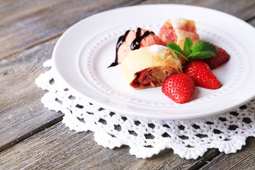 Tasty homemade strudel with ice-cream, fresh strawberry and