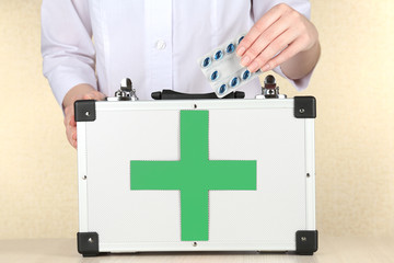 Nurse holding first aid kit, close up