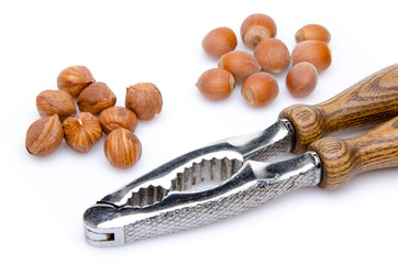 Opened and whole hazelnuts with a nutcracker