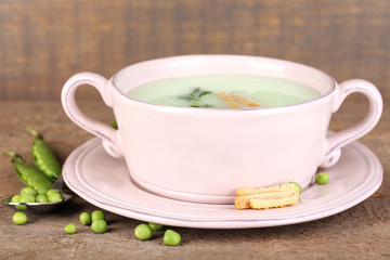 Tasty peas soup on wooden table