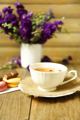 Cup of fresh herbal tea on wooden table