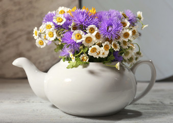 Kitchen decoration with teapot and wild flowers