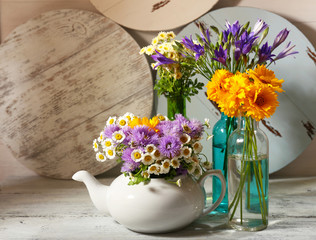 Kitchen decoration with teapot and wild flowers