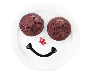 Two tasty muffins on plate isolated on white
