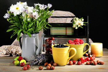 Still life with flowers and fruits on dark background