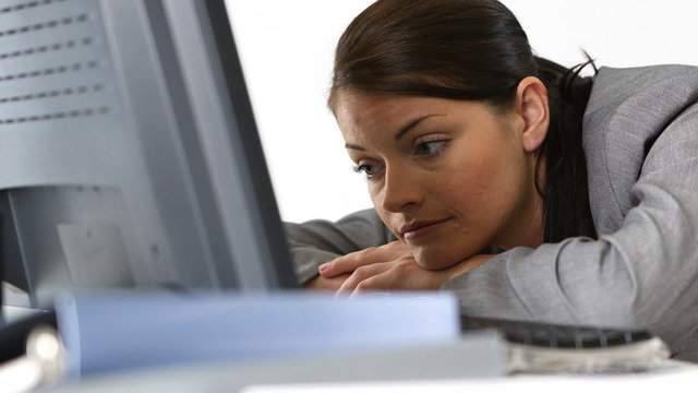 Close up of concerned young businesswoman at desk with computer