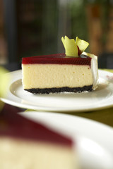 close up red cherry cheese cake on white dish