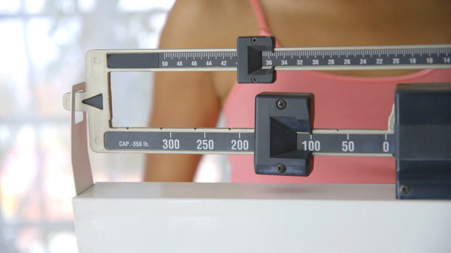 Close up of hand adjusting scale