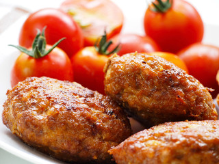 Homemade patties and cherry tomatoes