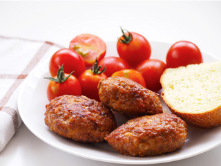 Homemade patties, cherry tomatoes and bread