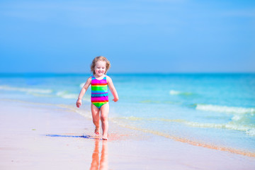Little girl running on a beach