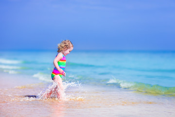 Little girl running on a beach