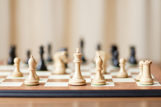 Chess pieces set on a chessboard