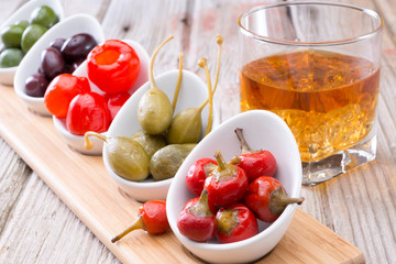Savory peppers and olives served with whiskey