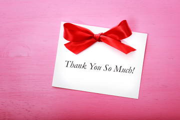 Thank you card on pink wooden board