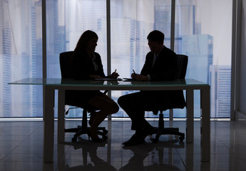 Business People Discussing At Desk In Office