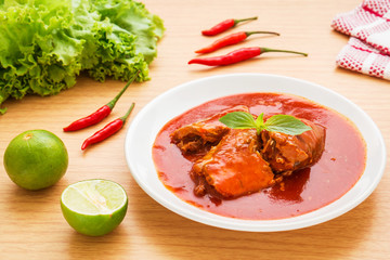Canned fish in tomato sauce on plate