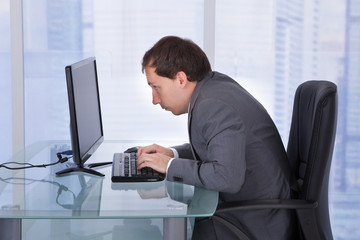 Concentrated Businessman Working On Computer In Office