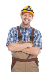 Smiling Male Worker Standing Arms Crossed Over White Background