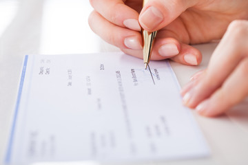 Businesswoman Signing Cheque
