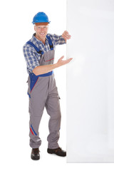 Confident Manual Worker Holding Billboard