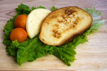 French toast, cheese and tomatoes on lettuce leaf
