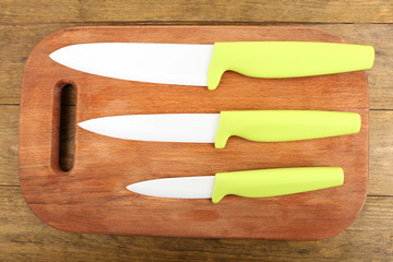 Kitchen knives and cutting board on wooden table
