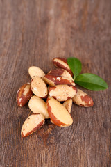 Tasty brasil nuts on wooden background