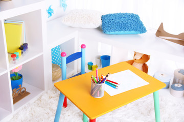 Modern playroom for children with bright table