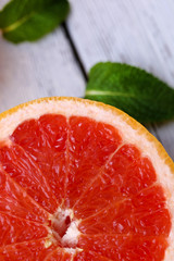 Ripe grapefruits on color wooden background