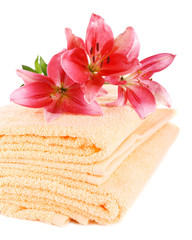 Obraz na płótnie Canvas Color towels and lily flowers, isolated on white