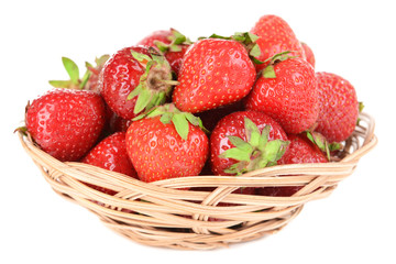 Ripe sweet strawberries in wicker basket isolated on white