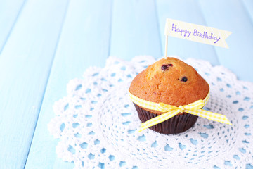 Blueberry muffins on color wooden background