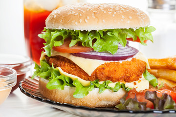 Chickenburger and glass of cola with ice
