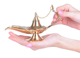 Magic lamp in female hands isolated on white