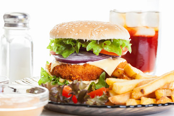 Chickenburger and glass of cola with ice
