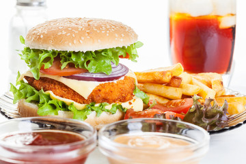 Chickenburger and glass of cola with ice