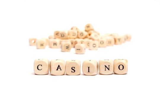 word with dice on white background- casino