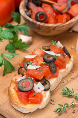 ciabatta with tomatoes, olives, parmesan on board