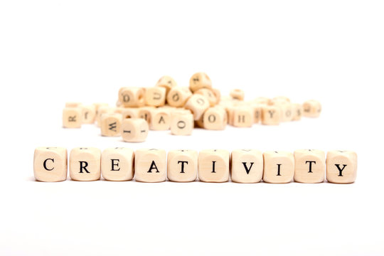 word with dice on white background- creativity
