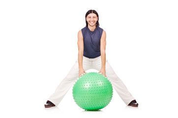 Man with swiss ball doing exercises on white